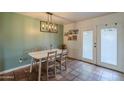 Charming dining room with light fixture, seating for four, and french doors to the outdoors at 2818 E Clarendon Ave, Phoenix, AZ 85016
