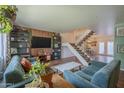 Spacious living room with open staircase, comfortable blue sofas, and integrated entertainment center with shelving at 2818 E Clarendon Ave, Phoenix, AZ 85016
