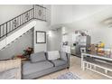 Open concept living room and dining room featuring high ceilings and staircase at 3646 N 67Th Ave # 29, Phoenix, AZ 85033