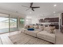 Open-concept living room with sliding glass doors, comfortable seating, and a seamless transition to the kitchen at 36922 N Camarillo Dr, San Tan Valley, AZ 85140