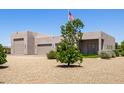 Front yard with desert landscaping and a three-car garage at 38415 N 25Th Ave, Phoenix, AZ 85086