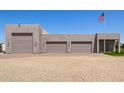 A detached three-car garage with desert landscaping on a sunny day at 38415 N 25Th Ave, Phoenix, AZ 85086