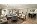 Bright, open-concept living room with modern furnishings that flows into kitchen area at 547 W Orangewood Ave, Phoenix, AZ 85021