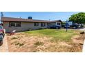 Modest single-story home with lawn, driveway and residential character at 6063 W Earll Dr, Phoenix, AZ 85033