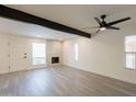 Inviting living room featuring a modern fireplace, wood flooring, and ample natural light from large windows at 6544 N 7Th Ave # 14, Phoenix, AZ 85013
