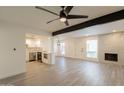 Bright, open-concept living area with wood flooring, stylish lighting, and a modern kitchen and fireplace at 6544 N 7Th Ave # 14, Phoenix, AZ 85013