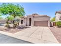 Inviting single-story home with landscaped front yard, desert plants, and a two-car garage at 7532 E Sierra Morena Cir, Mesa, AZ 85207