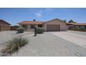Charming single-story home with desert landscaping, gravel yard, and a two-car garage at 7549 W Yucca St, Peoria, AZ 85345