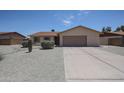 Single-story home with desert landscaping, gravel yard, and a two-car garage at 7549 W Yucca St, Peoria, AZ 85345
