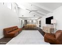 Bright open-concept living room with vaulted ceilings, a modern ceiling fan, and stylish furnishings at 8007 E Del Tesoro Dr, Scottsdale, AZ 85258