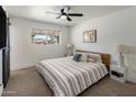 Cozy bedroom featuring a ceiling fan and a bright window at 8022 E Columbus Ave, Scottsdale, AZ 85251