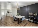 Elegant dining room with modern light fixture, marble table, and wine bar at 8022 E Columbus Ave, Scottsdale, AZ 85251