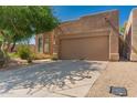 Desert home with a two car garage and desert landscaping at 8324 E Cactus Wren Rd, Scottsdale, AZ 85250