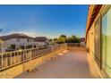 Spacious tiled balcony with views of the neighborhood and clear blue sky at 8621 W Morten Ave, Glendale, AZ 85305