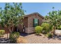 Close up of a well-maintained side yard, featuring low-maintenance landscaping and desert-friendly plants at 8735 N 185Th Ave, Waddell, AZ 85355