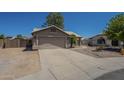Charming single-story home with well-maintained front yard, two-car garage, and desert landscaping at 890 N Bogle Ct, Chandler, AZ 85225