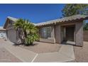 Inviting home entrance with decorative landscaping and a covered walkway to the front door at 890 N Bogle Ct, Chandler, AZ 85225