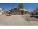 Charming single-story home with well-maintained front yard, two-car garage, and desert landscaping at 890 N Bogle Ct, Chandler, AZ 85225