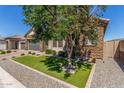 Inviting single-story home showcasing a stone facade, desert landscaping, and a well-manicured lawn at 9029 S 15Th St, Phoenix, AZ 85042