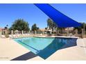 Sparkling community pool with lounge chairs and sunshade for residents at 9235 N 101St St, Scottsdale, AZ 85258