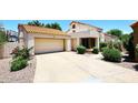 Home exterior boasts a tile roof, two-car garage, and desert landscaping at 9235 N 101St St, Scottsdale, AZ 85258