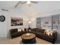Spacious living room with vaulted ceiling, comfortable seating, ceiling fan, and neutral carpet at 10115 E Mountain View Rd # 2061, Scottsdale, AZ 85258