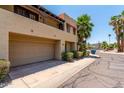 Attractive multi-level condo features an attached garage and a view of tropical landscaping at 10235 N 31St St # 2, Phoenix, AZ 85028