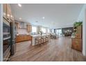 Spacious kitchen featuring a center island that seamlessly flows into the dining and living areas at 10964 W Garfield St, Avondale, AZ 85323
