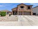Well-maintained two-story home features stucco and brick accents, three-car garage, and inviting curb appeal at 1130 E Harvest Rd, San Tan Valley, AZ 85140