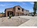 Spacious two-story home boasts stucco and brick exterior, three-car garage, and low maintenance landscaping at 1130 E Harvest Rd, San Tan Valley, AZ 85140