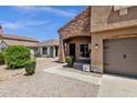 Inviting front porch features brick accents, well-manicured landscaping, and a welcoming entrance at 1130 E Harvest Rd, San Tan Valley, AZ 85140