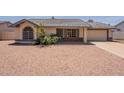 A charming single-story home featuring a tidy front yard and a two-car garage, with a tile roof at 1165 E Ivanhoe St, Chandler, AZ 85225