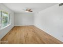 Bright, vacant bedroom featuring hardwood floors, neutral walls, and a ceiling fan at 1306 W 12Th St, Tempe, AZ 85281