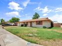 Inviting single-story home with a well-manicured lawn and tidy landscaping at 1306 W 12Th St, Tempe, AZ 85281