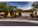 Charming single-story home featuring desert landscaping, warm exterior paint, and a two-car garage at 13145 W Whisper Rock Trl, Peoria, AZ 85383