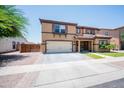 Charming two-story home with a well-maintained front yard and a cozy front porch at 13601 W Hearn Rd, Surprise, AZ 85379