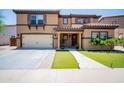 Inviting two-story home featuring a tile roof, manicured lawn, and a welcoming front porch at 13601 W Hearn Rd, Surprise, AZ 85379