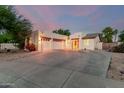 Beautiful desert home with three-car garage, ample driveway space, and manicured landscaping at 14687 W Amelia Ave, Goodyear, AZ 85395