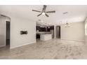 Spacious living area open to kitchen, featuring stylish tile flooring and neutral tones at 15078 W Mckinley St, Goodyear, AZ 85338