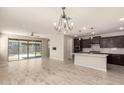 Bright, open-concept living space with sliding glass doors and views into the kitchen at 15078 W Mckinley St, Goodyear, AZ 85338