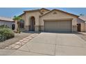 Inviting single-Gathering home with a two-car garage, desert landscaping, and a tile roof at 16126 N 159Th Dr, Surprise, AZ 85374
