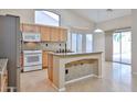 Spacious kitchen featuring granite countertops, island and a white range at 16126 N 159Th Dr, Surprise, AZ 85374