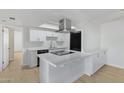 Modern kitchen with white cabinetry, stainless steel appliances, and sleek countertops at 1631 E Newport Dr, Tempe, AZ 85282