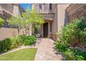 Inviting front entrance with brick pathway and lush landscaping creates a welcoming ambiance at 16425 S 34Th St, Phoenix, AZ 85048