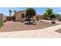 Charming home featuring desert landscaping with natural stone and a brick paved driveway at 1643 N 144Th Dr, Goodyear, AZ 85395
