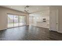 Open-concept living area with sliding glass door, flowing into a stylish kitchen at 16836 W Vereda Solana Dr, Surprise, AZ 85387