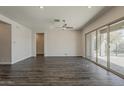 Expansive living room with dark flooring and a sliding glass door to the backyard at 16836 W Vereda Solana Dr, Surprise, AZ 85387
