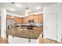 Well-equipped kitchen boasting stainless steel appliances and granite countertops at 1721 W Kingbird Dr, Chandler, AZ 85286