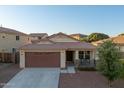 Lovely single-story home with a two-car garage, welcoming porch, and well-maintained front yard at 18344 W Getty Dr, Goodyear, AZ 85338