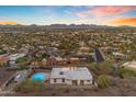 Expansive aerial view of a vibrant residential community with homes, palm trees, and a beautiful sky at 1917 E Karen Dr, Phoenix, AZ 85022